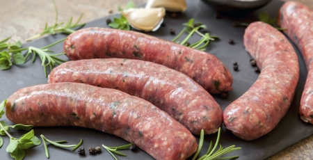 raw sausages on a cutting board